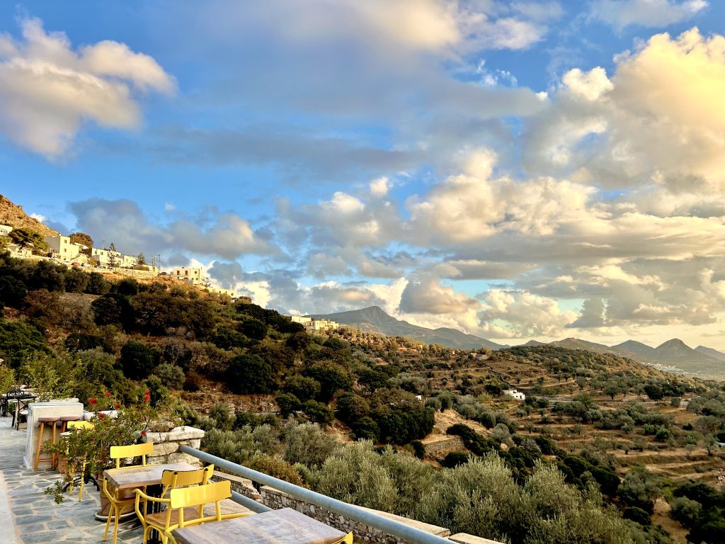 Aerial panoramic view of ELaiolithos surrounded by the traditional mountain villages of Naxos with the majestic Mount Zeus in the background.