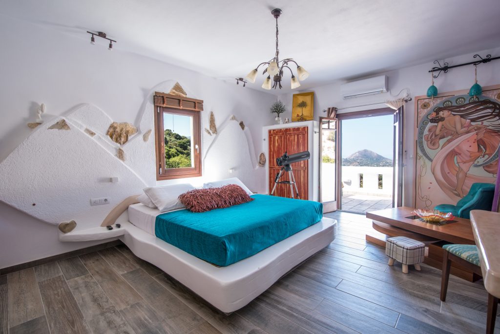 Helen of Troy (Oraia Eleni) suite at ELaiolithos in Naxos with private balcony, panoramic 500-meter views of Tragea Valley, mountain villages, and the Aegean Sea