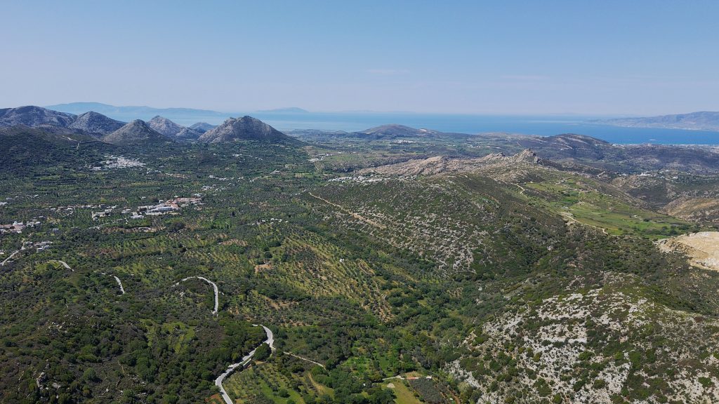 Scenic panorama from ELaiolithos in Naxos showing mountain ridges, traditional villages, the fertile Tragea Valley, and the Aegean Sea horizon
