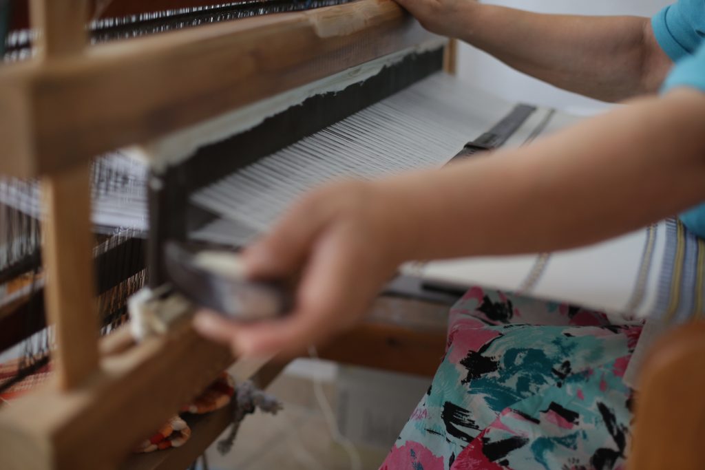 Traditional loom weaving in Naxos with handmade textiles used in the suites at ELaiolithos
