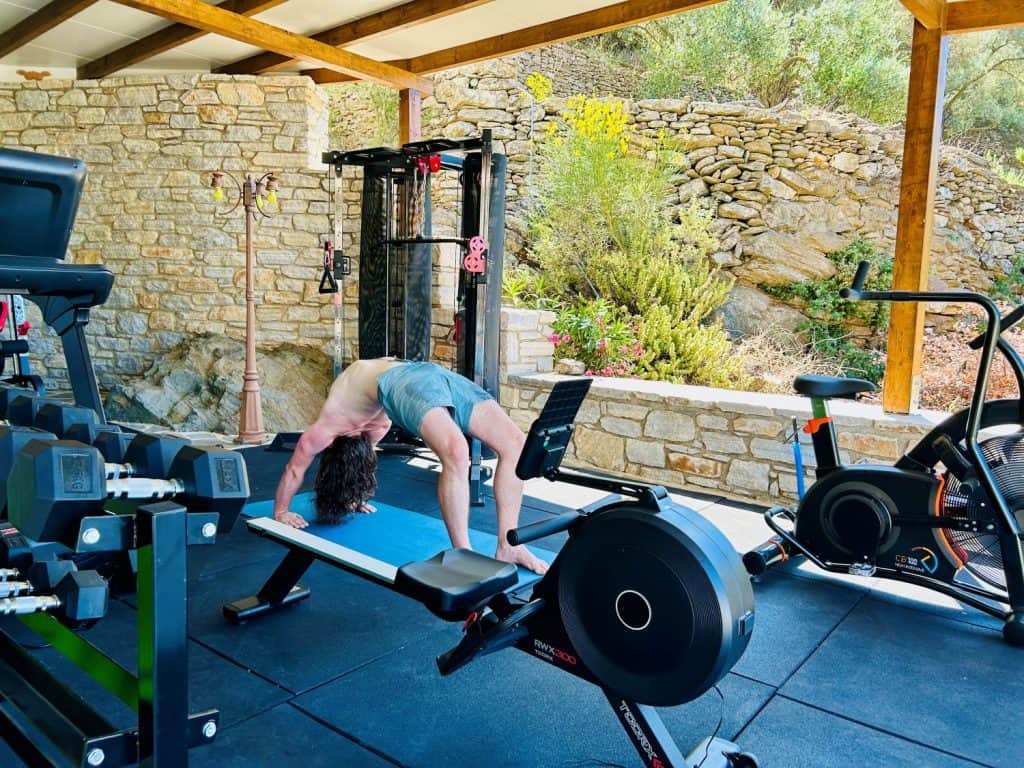 Fitness gym at ELaiolithos in Naxos with exercise equipment and views of the island landscape