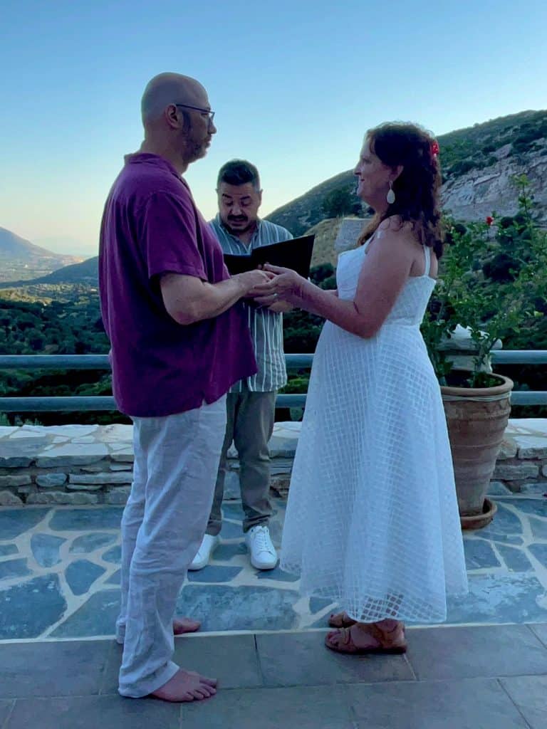 Couple renewing their wedding vows at ELaiolithos in Naxos overlooking the Aegean landscape.