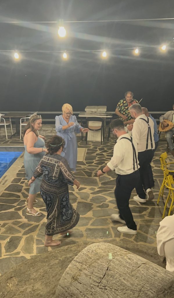 Wedding guests dancing on the terrace at ELaiolithos in Naxos during a live music celebration